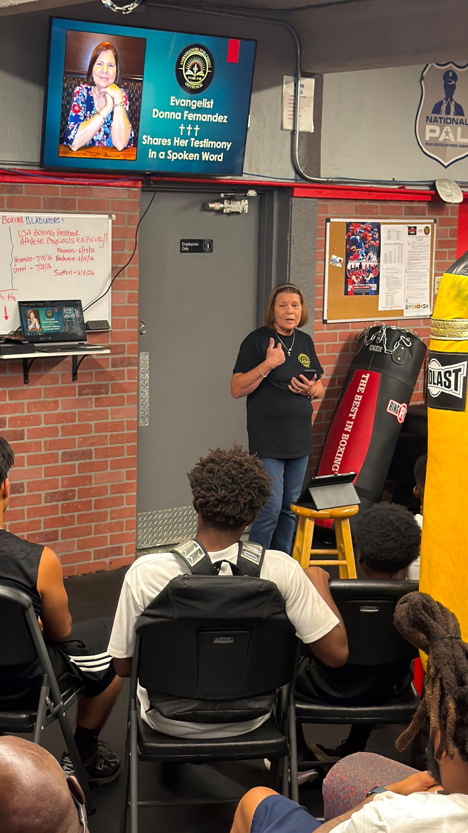 Donna Fernandez shares her testimony in a spoken word as young people listen.